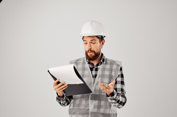 male worker in a gray vest construction work design studio industry