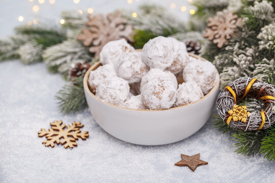 Traditional Christmas snowball cookies with almonds on snowy  background