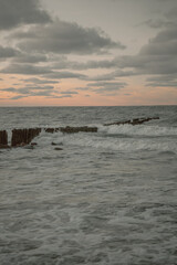 Waves and storm at sea. Waves crash against breakwaters. Splashes of the sea wave. Baltic Sea.