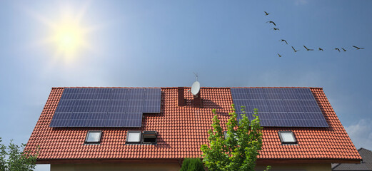 Renewable green energy solar panels on house roof.