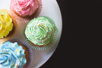 colorful cupcakes on black background