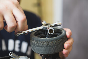Young Caucasian male assembling toy RC car at home in the evening