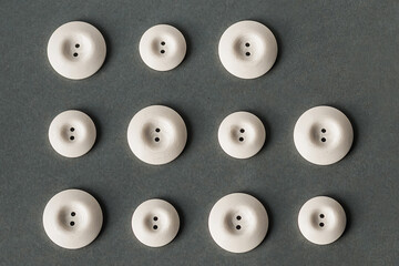 Background for design and banner. White buttons of different sizes on a gray background. Pattern