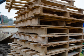 Old used empty Wooden pallets stored on construction site