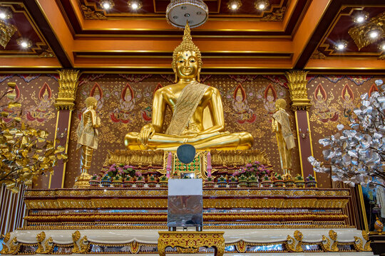A with golden statue of Buddha at Buddhist temple Wat Khun Inthapramun.