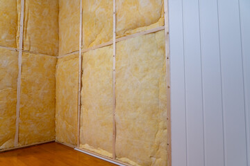 Inside wall heat isolation with mineral wool in wooden house.