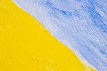 abstract colored creative background: stains of blue and yellow paint-primer on a rough linen...