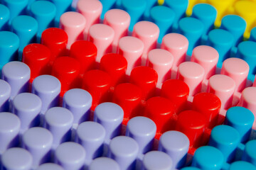 children's play background: the plane of plastic multi-colored bricks, blur, selective focus