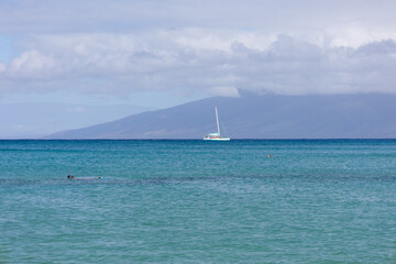 Sailboat in the open sea. Calm sea sailing, luxury summer adventure, active vacations. Maui, Hawaii