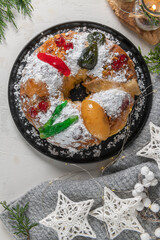 Bolo Rei or King's Cake is a traditional Xmas cake with fruits raisins nut and icing  on kitcthen countertop. Is made for Christmas, Carnavale or Mardi Gras