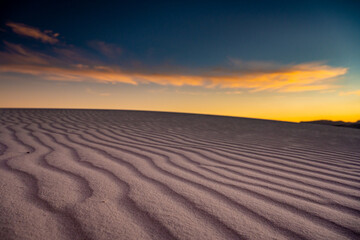 Fototapeta na wymiar Blue and Orange Skies Over white sand dunes