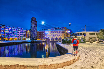 Beautiful night in Riva del Garda on a winter day with lots of snow, View of the beautiful Lake...