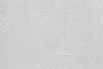 The wall of the cement building is painted white texture and background seamless