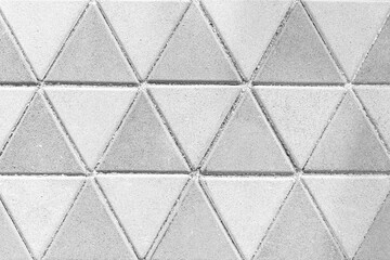 White cement block floor tile with triangular pattern and background seamless