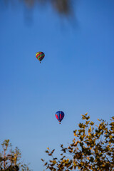 Hot air balloon flying over a community