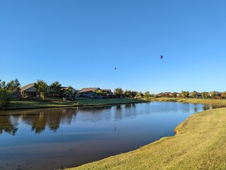Hot air balloon flying over a community