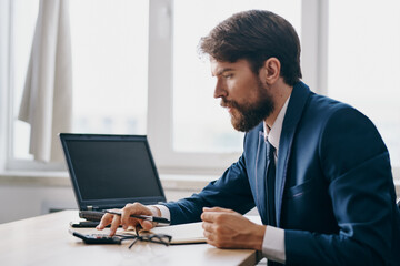Fototapeta premium manager working for a laptop in the office emotions discontent professional