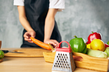 housewife on the kitchen cutting vegetables cutting board