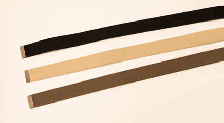 Three colorful canvas belts shot isolated against a white background. 