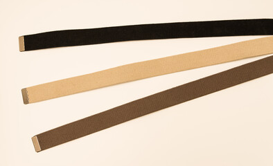 Three colorful canvas belts shot isolated against a white background. 