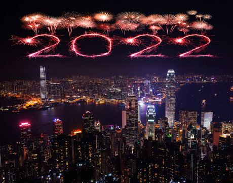 2022 Happy New Year fireworks over Hong Kong cityscape at night - Powered by Adobe