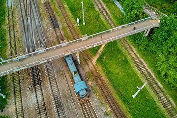 Pedestrian bridge over the railroad tracks and trolley, view from above