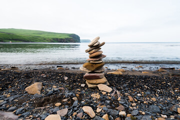 Stones pyramid on the seashore.