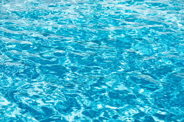Abstract ripple wave and clear turquoise water surface in swimming pool, blue water wave for background and abstract design.