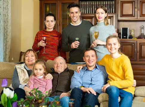 Portrait of big family members posing together in living room