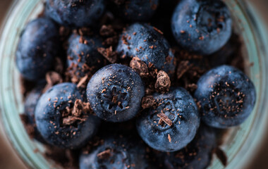 Healthy chia pudding with blueberries in jar on the rustic background. Selective focus. Shallow depth of field.