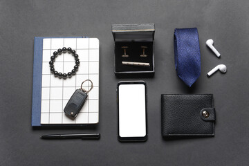 Set of stylish male accessories on dark background
