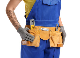 Fototapeta na wymiar Female construction worker with tools on white background