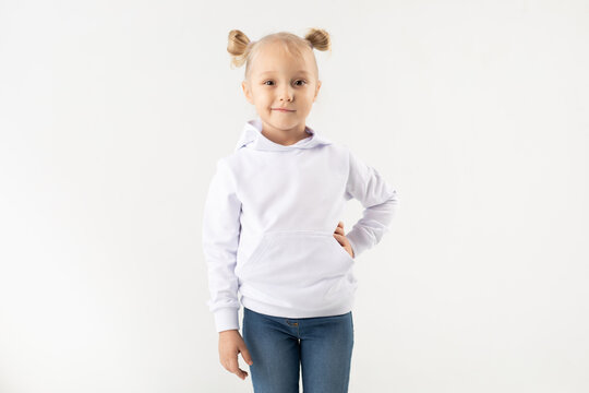 Cute little girl in a white hoodie on a white background. Mock-up.