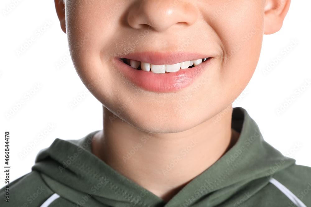 Wall mural Little boy with healthy smile on white background, closeup