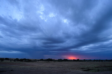 Fototapeta na wymiar clouds over the landscape with sun setting.