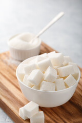 White granulated sugar and sugar cubes