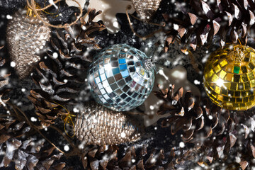Christmas ornament background from toys, cones, snow, mirror balls