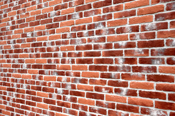 Wall texture of bright red brick with decorative white spots, perspective view