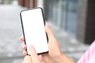 Woman using mobile phone near modern building, closeup