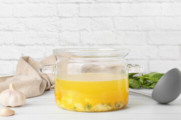 Cooking pot with tasty dumpling soup on table