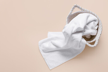 Basket with white clean towel on color background