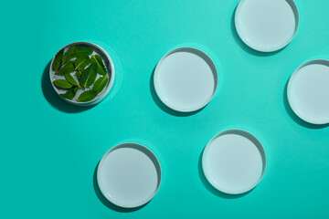 Pattern from cream with mint on a turquoise background, the concept of skin care and cosmetology.