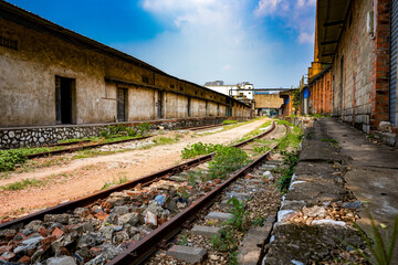 China's abandoned red brick factory buildings and freight railway tracks