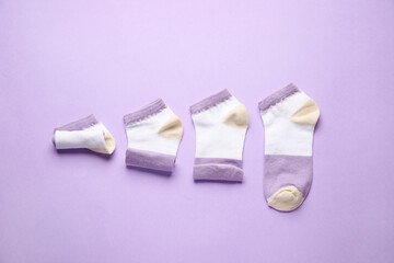 Stylish socks on lilac background