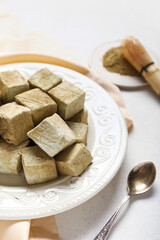 Plate with Tasty hojicha marshmallows on light background, closeup