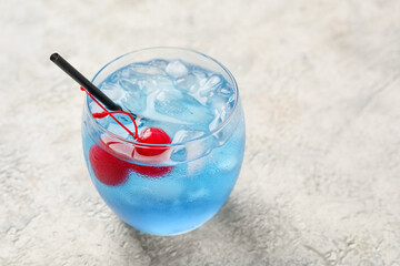Glass of Blue Lagoon cocktail on light background, closeup
