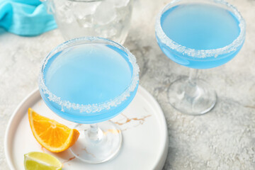 Glasses of Blue Lagoon cocktail on light background, closeup