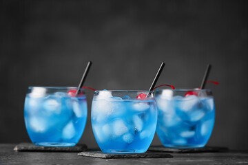 Glasses of Blue Lagoon cocktail on table, closeup