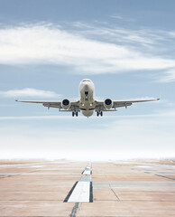 Fototapeta na wymiar White passenger airliner take off from airport runway