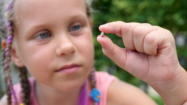 Little girl with milk temporary wobbly tooth. Dental medicine or temporary teeth healthcare concept. Tooth Fairy